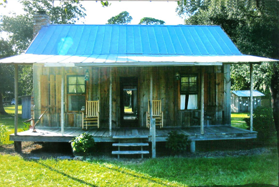 A Cracker house with a detached kitchen.